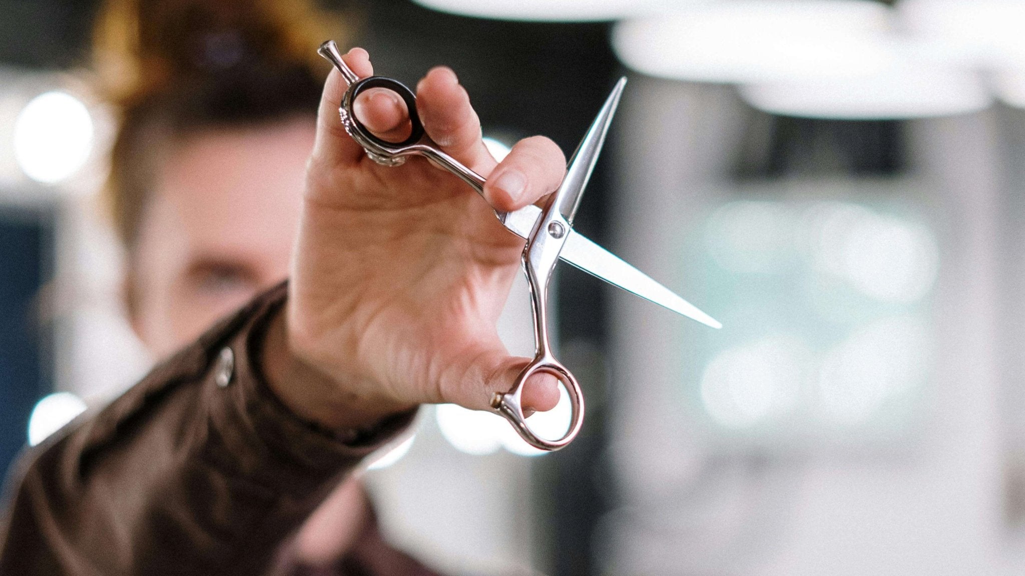 Experte für Haarsystem posiert mit Schere
